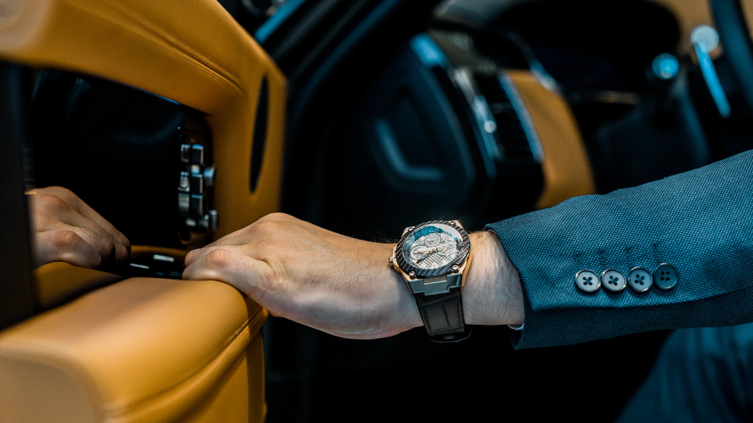 Principal hand and wristwatch inside a private vehicle