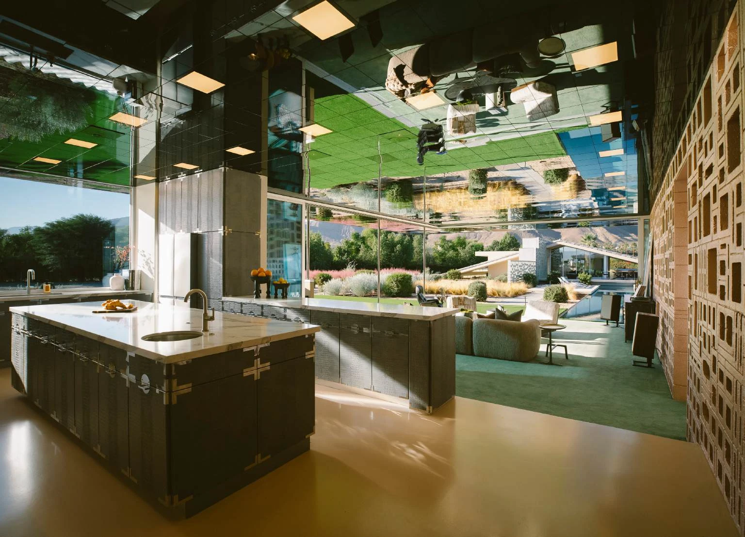 Kitchen at The Dreamer Estate with reflective ceiling and green palette.