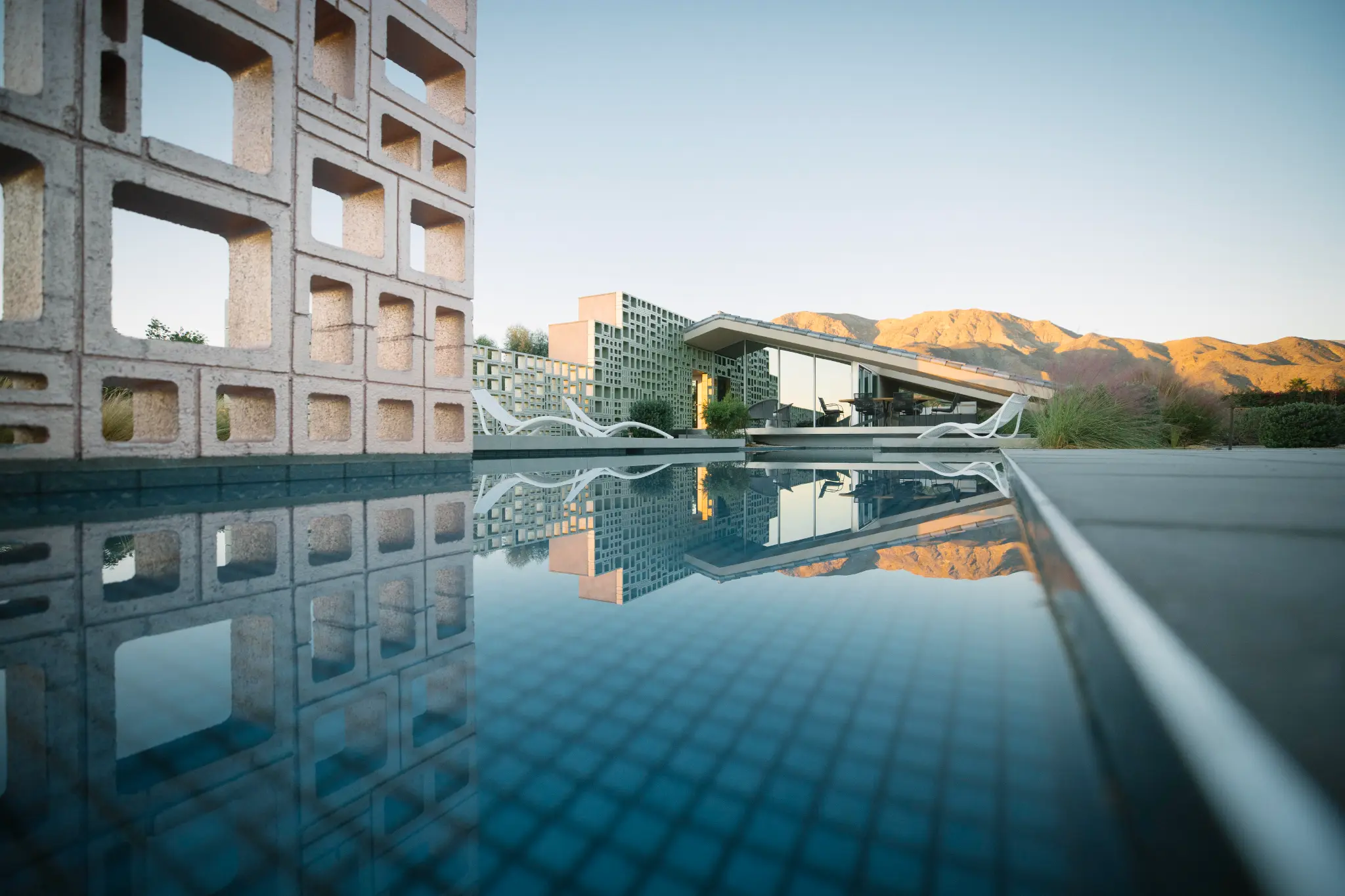 Lil’ Dreamer, the second residence, reflected in the pool at The Dreamer Estate.